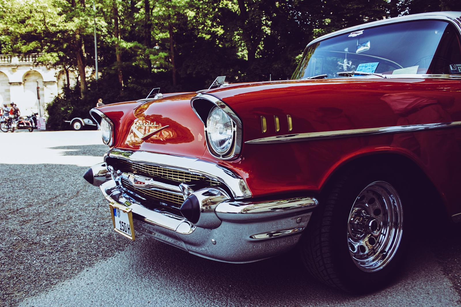 classic car Close-up of a classic red vintage car with chrome details parked outdoors in sunlight.